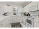 Bright kitchen featuring white appliances, cabinets, countertops and tile floors at 4261 Hibiscus Dr. # 4-104, Little River, SC 29566