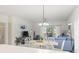 Open-concept living room and dining room featuring a glass table and a blue sofa at 4261 Hibiscus Dr. # 4-104, Little River, SC 29566