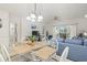 Comfortable living room with glass table and six white chairs and a blue sofa and chair at 4261 Hibiscus Dr. # 4-104, Little River, SC 29566