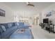 Open living room featuring a blue sectional sofa, dining area, and a view of the kitchen at 4261 Hibiscus Dr. # 4-104, Little River, SC 29566