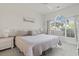 Inviting main bedroom featuring a plush bed, neutral decor, and a large window providing ample natural light at 4261 Hibiscus Dr. # 4-104, Little River, SC 29566