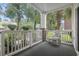 Covered patio with white railing and a view of the landscaped grounds, creating a relaxing outdoor space at 4261 Hibiscus Dr. # 4-104, Little River, SC 29566