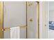 Bathroom showing a glass-door shower with gold trim and a white towel hanging on the door at 4261 Hibiscus Dr. # 4-104, Little River, SC 29566