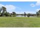 A grassy backyard flows into a pond, providing scenic views at 4290 Pinehurst Circle # B3, Little River, SC 29566