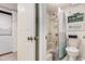 Bathroom with a shower and tub, a toilet, laundry room, and gold hardware at 4290 Pinehurst Circle # B3, Little River, SC 29566