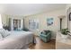 Bright bedroom with hardwood floors, stylish chair and lamp, and bright natural light at 4290 Pinehurst Circle # B3, Little River, SC 29566