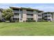 This condominium building showcases multiple balconies and beautiful, well-maintained landscaping at 4290 Pinehurst Circle # B3, Little River, SC 29566