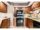 Traditional kitchen featuring wood cabinets, granite countertops, and modern appliances at 4290 Pinehurst Circle # B3, Little River, SC 29566