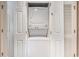 Laundry closet featuring stacked washer and dryer units, enclosed by white doors at 4290 Pinehurst Circle # B3, Little River, SC 29566