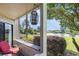 Screened in porch with seating and views of a lush landscape and scenic pond at 4290 Pinehurst Circle # B3, Little River, SC 29566