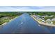 Stunning aerial view of a waterfront community with lush greenery and a charming lighthouse by the river at 4520 Lighthouse Dr. # 29B, Little River, SC 29566