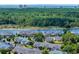 Beautiful aerial view showcases waterfront homes surrounded by dense trees with city skyline in the distance at 4520 Lighthouse Dr. # 29B, Little River, SC 29566