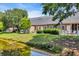Waterfront backyard with green grass, shrubbery, and a white fence at 4520 Lighthouse Dr. # 29B, Little River, SC 29566