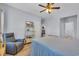 Comfortable bedroom features ceiling fan, light colored wood-look floors, and gray recliner at 4520 Lighthouse Dr. # 29B, Little River, SC 29566