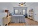 Comfortable bedroom with a ceiling fan, wood look floors, and sun-filled windows at 4520 Lighthouse Dr. # 29B, Little River, SC 29566