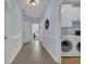 Inviting hallway with tile flooring leads to laundry room with washer and dryer at 4520 Lighthouse Dr. # 29B, Little River, SC 29566