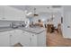 Bright kitchen with white cabinetry and bar seating, offering an open view into the dining and living area at 4520 Lighthouse Dr. # 29B, Little River, SC 29566