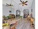 Open floor plan living room features an expansive mirror wall and wood-look flooring at 4520 Lighthouse Dr. # 29B, Little River, SC 29566