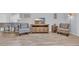 Cozy living room features modern furnishings, a mounted television, and light colored wood-look flooring at 4520 Lighthouse Dr. # 29B, Little River, SC 29566