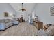 Open concept living room with wood-look floors, gray sofa, dining table, and mounted television at 4520 Lighthouse Dr. # 29B, Little River, SC 29566