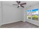 Bright bedroom with wood floors, ceiling fan, and a large window with views at 4532 Spyglass Dr., Little River, SC 29566