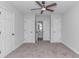 This carpeted bedroom boasts a ceiling fan, multiple closets, and access to an ensuite bathroom at 4532 Spyglass Dr., Little River, SC 29566