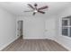 This bedroom features a ceiling fan and two entryways, all complemented by wood-look floors at 4532 Spyglass Dr., Little River, SC 29566