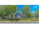 Charming exterior view of home with landscaped front yard, blue siding, and a welcoming neighborhood setting at 4532 Spyglass Dr., Little River, SC 29566