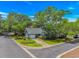 Charming blue home with lush landscaping, mature trees, and a well-maintained yard at 4532 Spyglass Dr., Little River, SC 29566