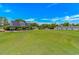 Spacious home with a large yard, manicured landscaping, and inviting curb appeal with barn in distance at 4532 Spyglass Dr., Little River, SC 29566