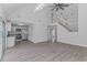 Open-concept living area with modern floors, vaulted ceiling, and access to the kitchen and stairs at 4532 Spyglass Dr., Little River, SC 29566