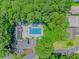 Aerial view of the community pool surrounded by trees, a parking lot, and residential buildings at 4532 Spyglass Dr., Little River, SC 29566