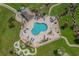 Beautiful aerial view of a community pool surrounded by lounge chairs and tropical palm trees at 4655 Wild Iris Dr. # 41-303, Myrtle Beach, SC 29577