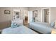 Inviting bedroom with two twin beds, soft color palette and natural light at 4655 Wild Iris Dr. # 41-303, Myrtle Beach, SC 29577