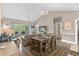 Cozy dining area with a view of the living room, kitchen, and balcony, and a rustic wooden table at 4655 Wild Iris Dr. # 41-303, Myrtle Beach, SC 29577
