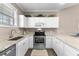 Well-lit kitchen features stainless steel appliances, white cabinetry, and granite countertops at 4655 Wild Iris Dr. # 41-303, Myrtle Beach, SC 29577