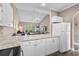 Bright kitchen with white cabinets and appliances, open to the dining and living areas at 4655 Wild Iris Dr. # 41-303, Myrtle Beach, SC 29577