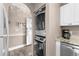 A convenient laundry area features stacked washer and dryer, plus storage and granite countertops at 4655 Wild Iris Dr. # 41-303, Myrtle Beach, SC 29577