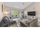Bright living room with vaulted ceilings, a ceiling fan, sliding glass doors to a balcony, and a view of the bedroom at 4655 Wild Iris Dr. # 41-303, Myrtle Beach, SC 29577
