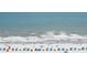 Beach view of the coastline with colorful umbrellas dotting the sandy shore at 4655 Wild Iris Dr. # 41-303, Myrtle Beach, SC 29577