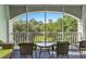 Relaxing screened porch with wicker furniture, great for enjoying the outdoor scenery at 4655 Wild Iris Dr. # 41-303, Myrtle Beach, SC 29577