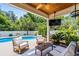 Outdoor living space with comfortable seating, a ceiling fan, and a view of the pool at 5 Ruth St., Murrells Inlet, SC 29576