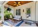 Covered back porch featuring a comfortable seating area with a fan and a tv at 5 Ruth St., Murrells Inlet, SC 29576