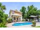 Charming backyard with a sparkling pool, lush landscaping, and a covered patio at 5 Ruth St., Murrells Inlet, SC 29576