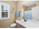 Bright bathroom with a vanity, toilet, and window at 5 Ruth St., Murrells Inlet, SC 29576
