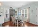 Dining area with stylish table, chairs, hardwood floors, and natural light from windows at 5 Ruth St., Murrells Inlet, SC 29576
