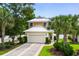 Charming home featuring a metal roof, two-car garage, manicured lawn, and beautiful palm trees at 5 Ruth St., Murrells Inlet, SC 29576
