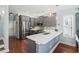 Modern kitchen featuring gray cabinets, stainless steel appliances, and quartz countertops at 5 Ruth St., Murrells Inlet, SC 29576