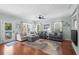 Bright living room featuring hardwood floors, comfortable seating, and multiple windows at 5 Ruth St., Murrells Inlet, SC 29576
