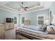 Serene main bedroom with tray ceilings, neutral tones, and large windows at 5 Ruth St., Murrells Inlet, SC 29576